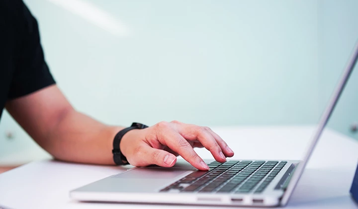 Hand auf laptop tastatur
